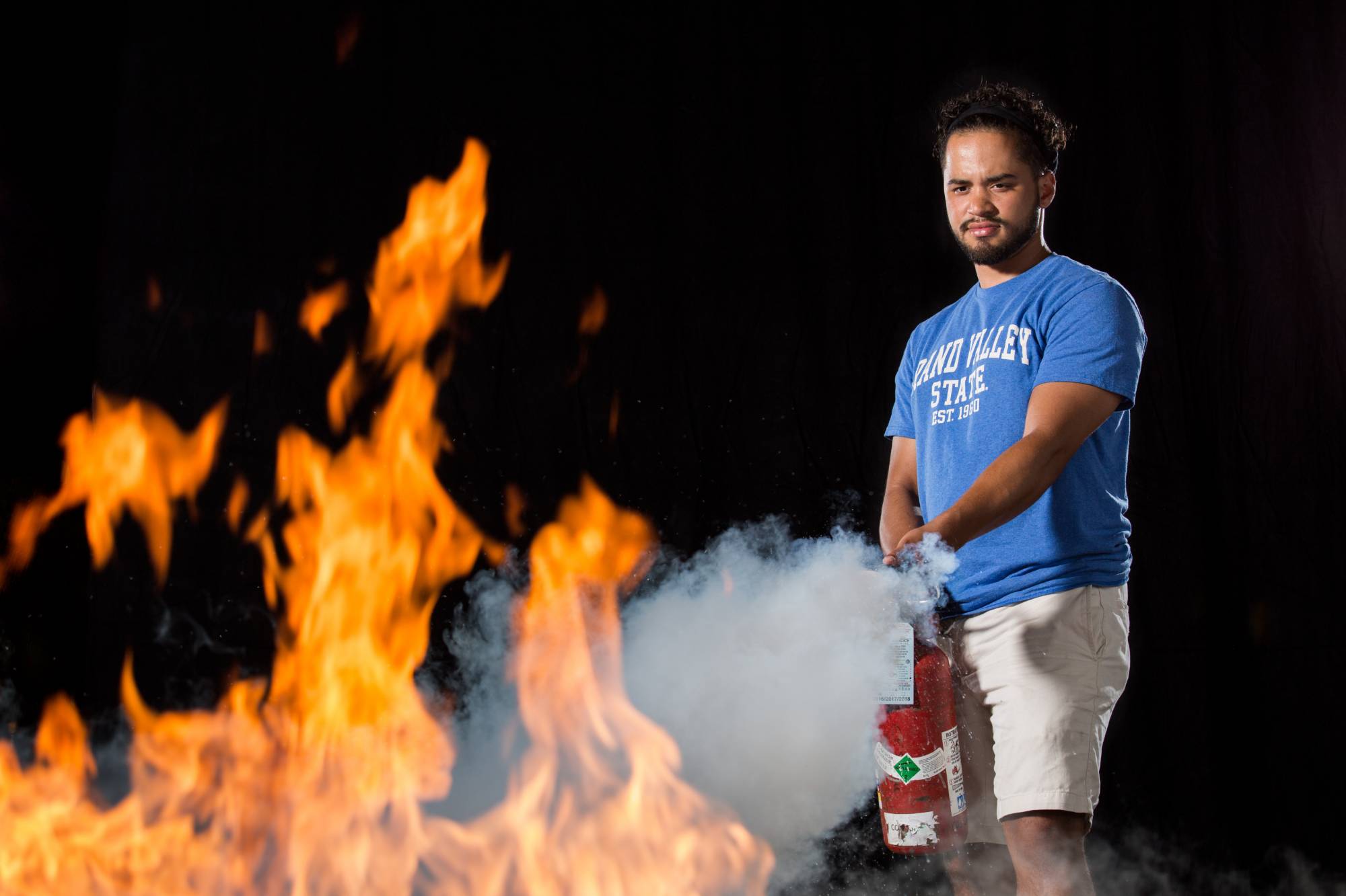 A student trains with a fire extinguisher
